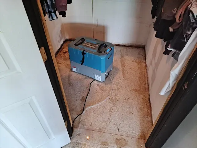 A blue cooler sitting in the middle of a room.